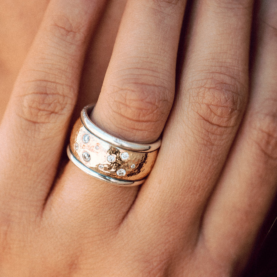 Our Wistra Ring, shown here, is a two tone mixed metal gold over silver wedding band with diamonds.